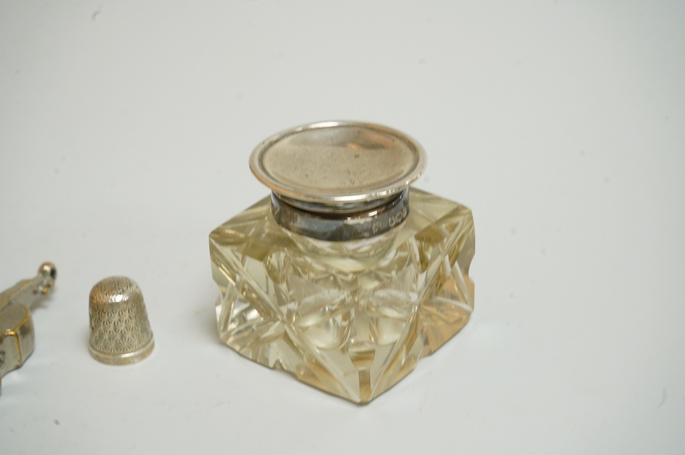 A small group of silver and other items, including an Edwardian silver mounted Common Prayer book(a.f.), a silver mounted matches holder, a silver mounted glass inkwell, a silver and mother of pearl fruit knife, two thim